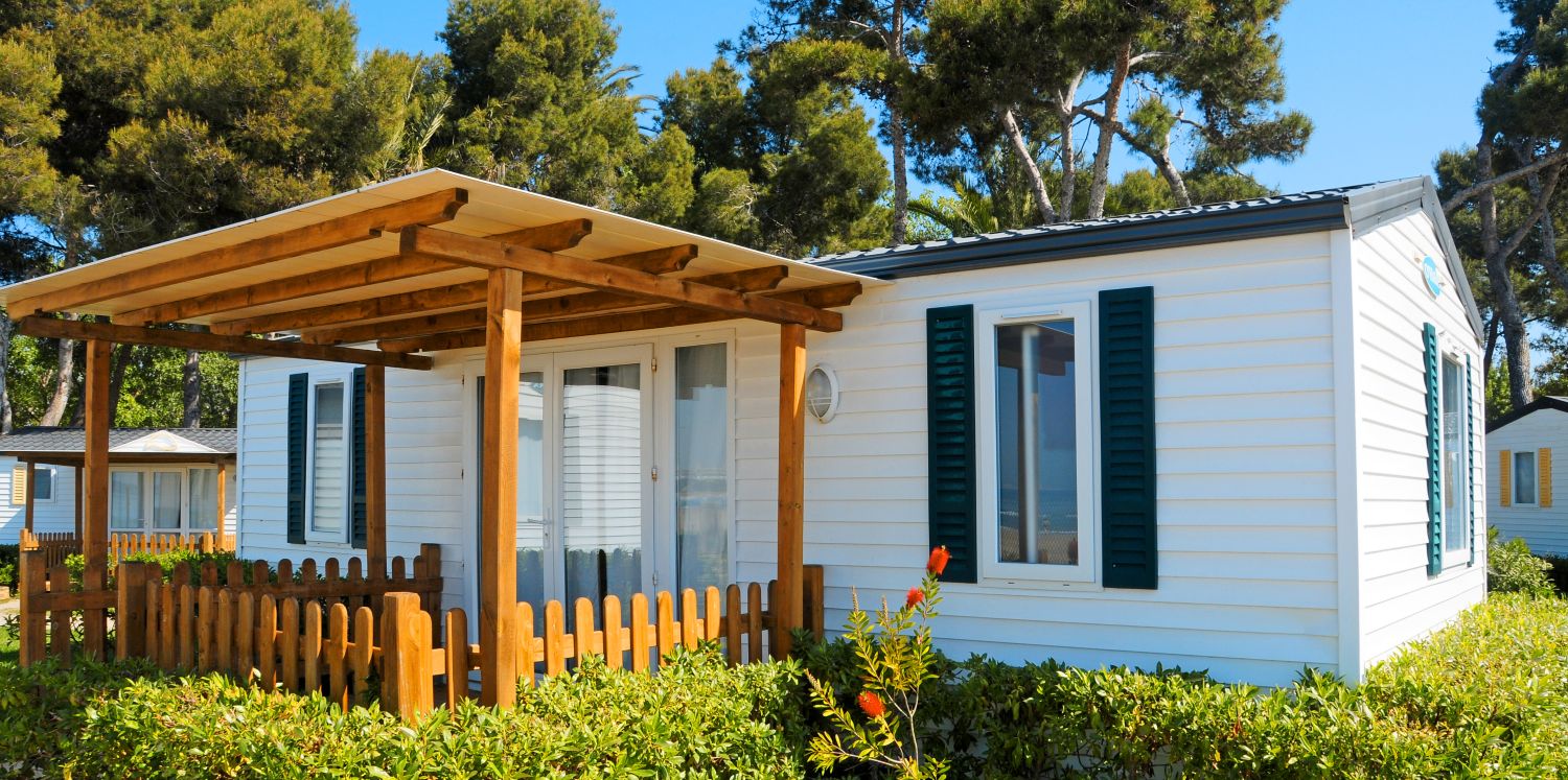 manufactured_home A small manufactured home with a garden and patio