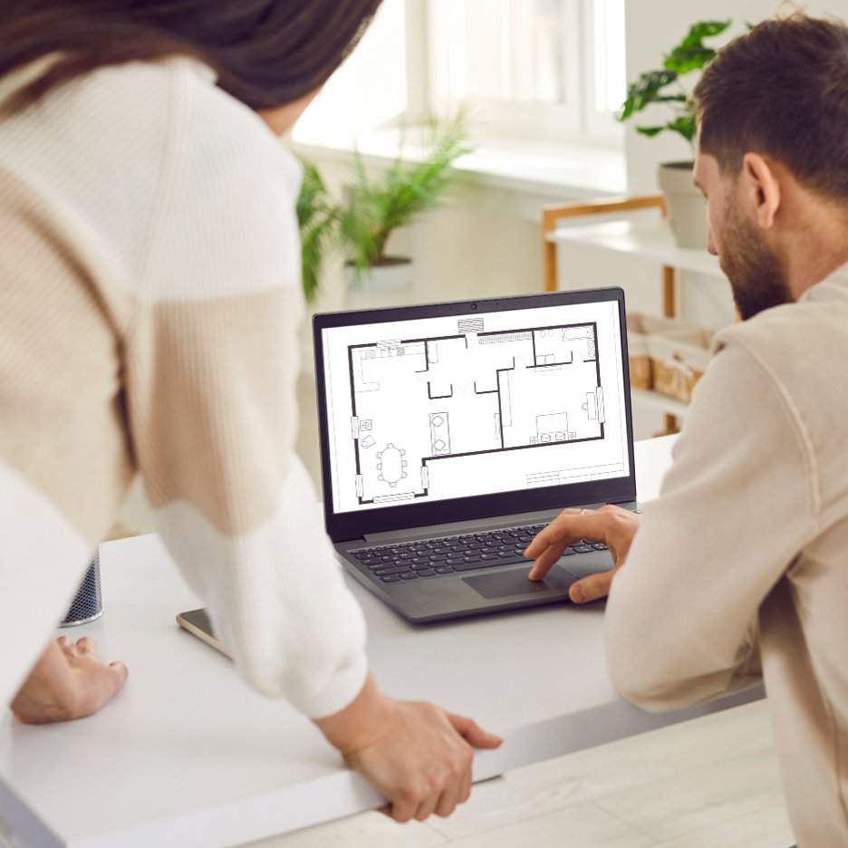 choosing_floorplan A couple reviewing floorplan options on a laptop